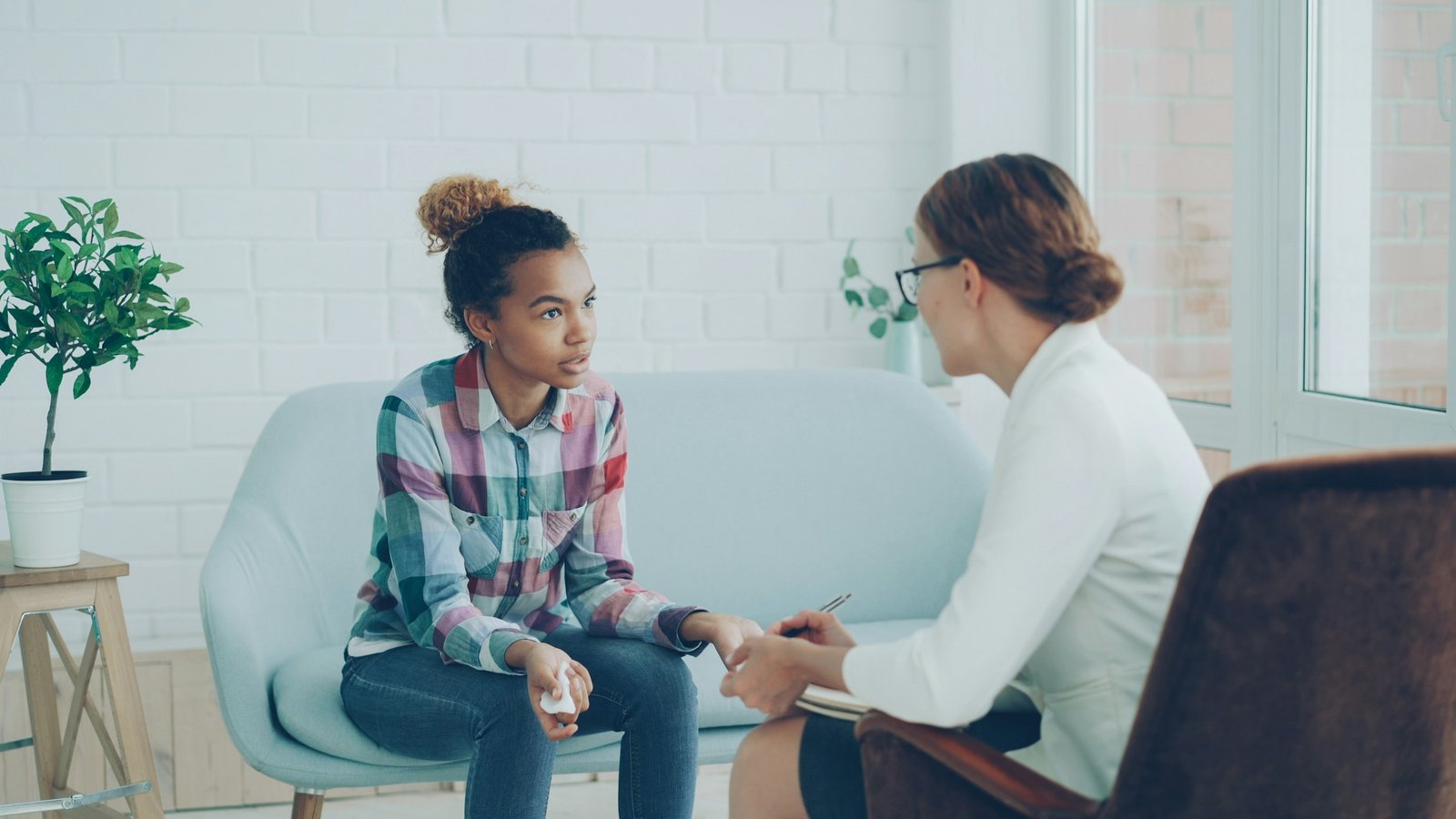 A supportive therapy conversation in a bright, welcoming room